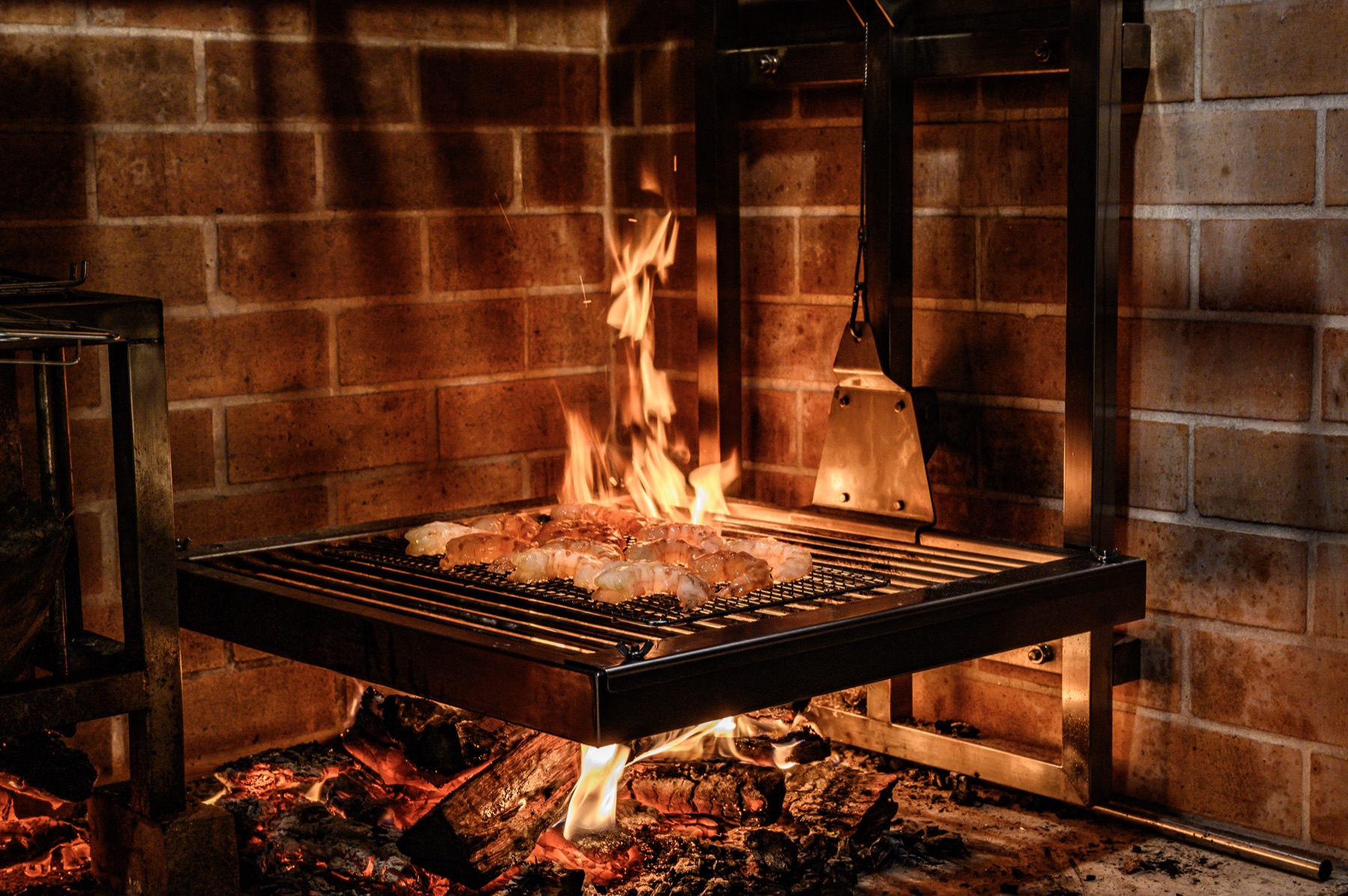 Food cooking over Nicola's open fireplace