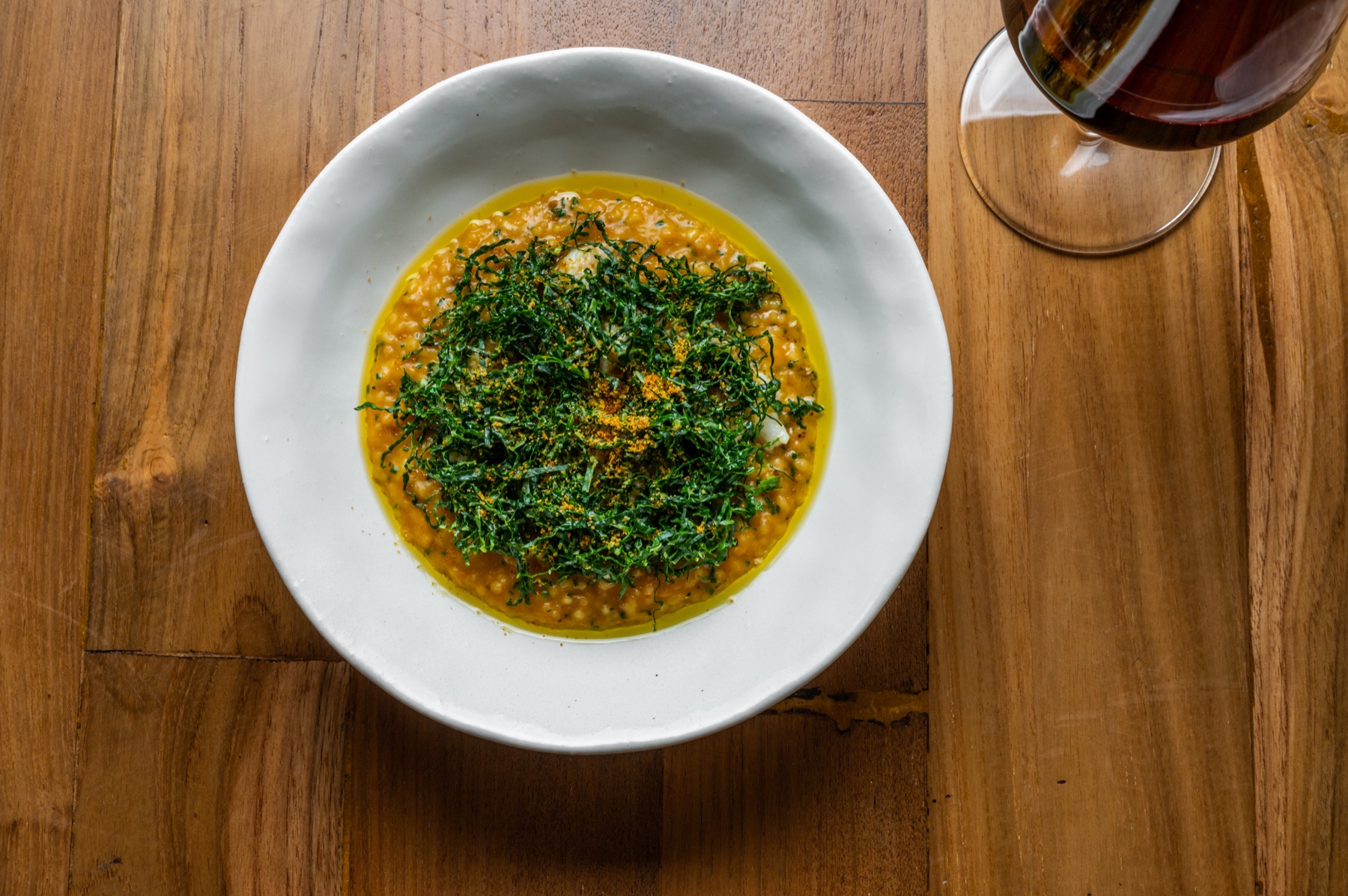 Golden risotto finished with fresh green herbs